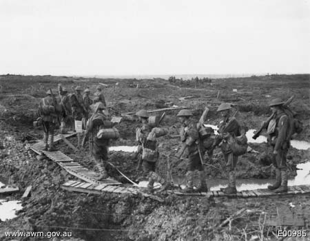 Australian 5th Division walking along winding
              duckboards at Passchendaele